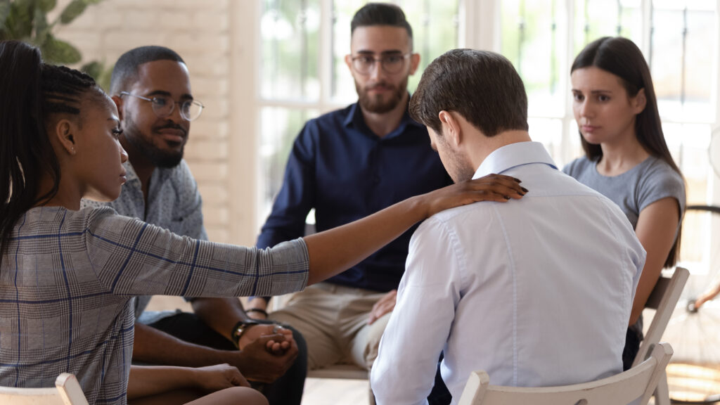 Man talking with support group about his depression