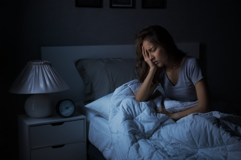 Woman sitting in bed depressed